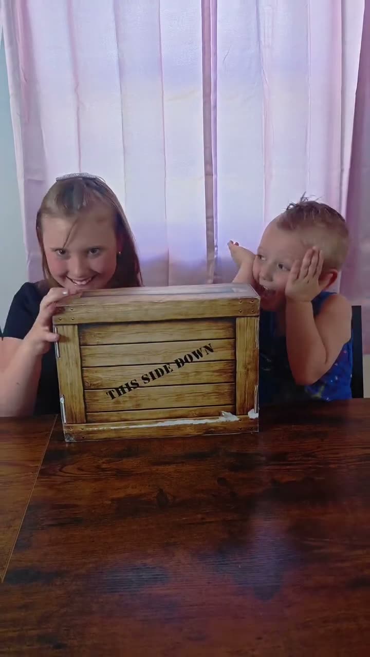 Two kids opening their Quest Club crate together
